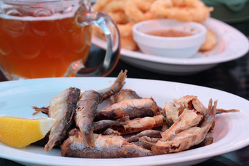 Plate full of fried sprats. Perfect snack.