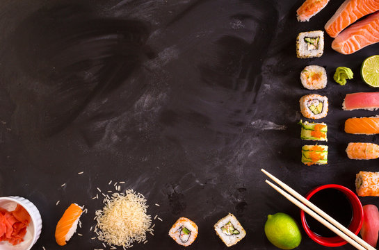 Sushi and ingredients on dark background