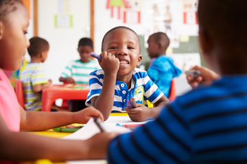 Preschool class in South Africa, boy looking to camera - obrazy, fototapety, plakaty