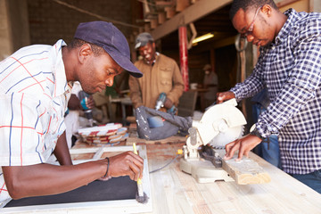 Three men at work in a carpentry workshop, South Africa - Powered by Adobe