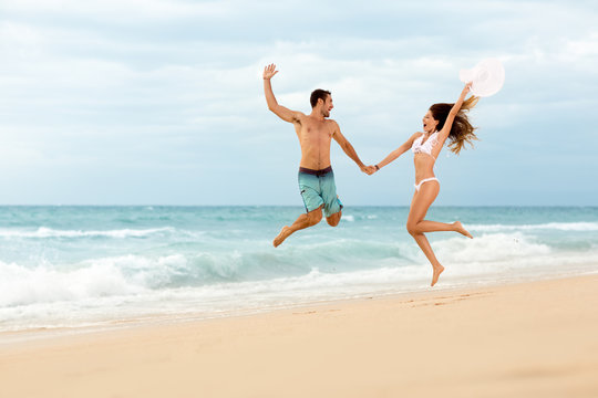 couple jumping on beach