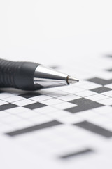 Crossword puzzle and pen