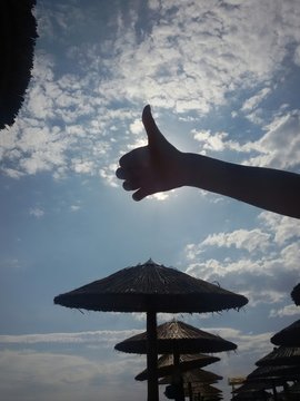 Girl holding Thumb up on the beach