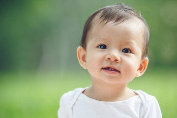 Baby happy in garden, new family and love concept (soft focus on