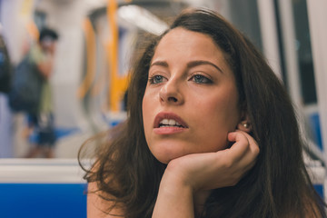 Beautiful curvy girl posing in a metro car