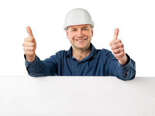 man in a construction helmet holding big white board