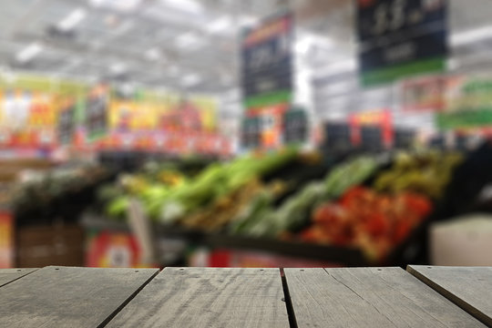 Defocus and blur image of supermarket on terrace wood background