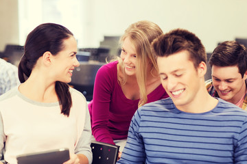 group of smiling students with tablet pc