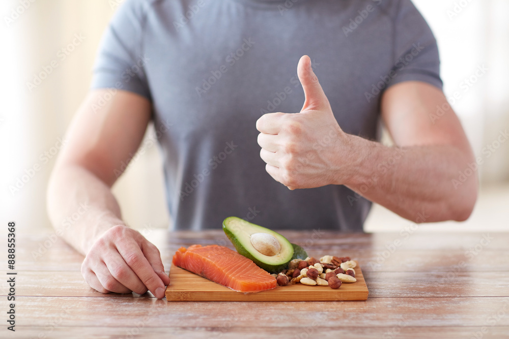 Wall mural close up of male hands with food rich in protein