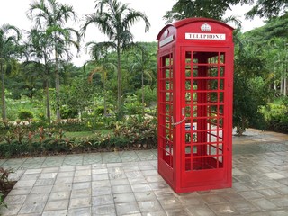 Red payphone box in park