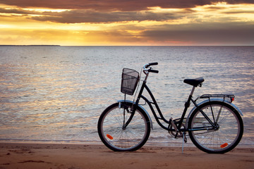 Lonely bike standing at sunset