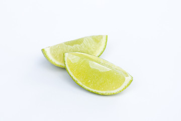 Limes with slices isolated on white background