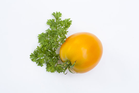 Tomato and parsley isolated on white