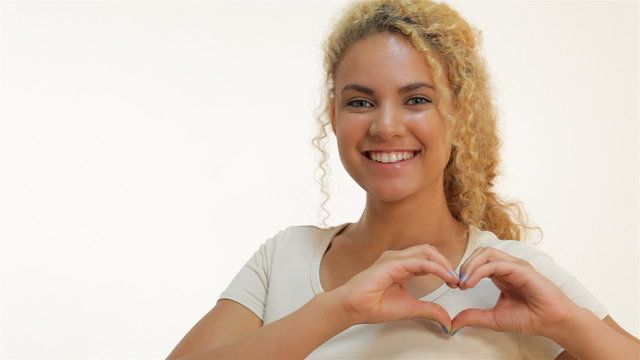 Red-haired mulatto showing heart shape gesture