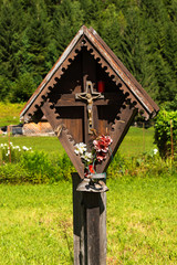 Wayside Shrine in Mountain - Trentino Italy. Typical wooden wayside shrine with jesus on cross in Italian alps. Trentino Alto Adige, Italy