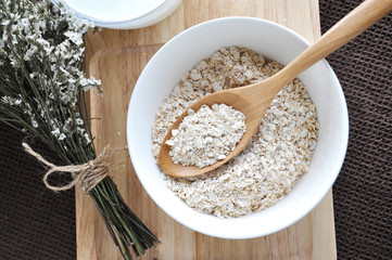 top view of oat in wooden spoon