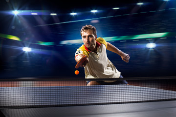 young sports man tennis player playing on black background with - obrazy, fototapety, plakaty