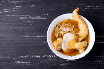 Top view at udon noodles with shrimp tempura with copy space on a left   Japanese cuisine. 