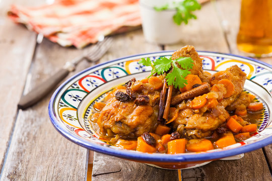 chicken with carrots and raisin maroc style on decorated bowl