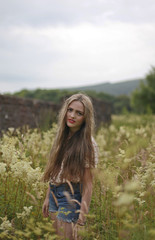teenage girl standing in a field of flowers