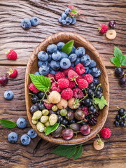 Ripe berries in the wooden bowl.