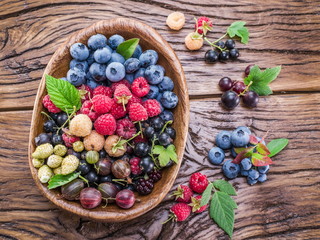 Ripe berries in the wooden bowl.
