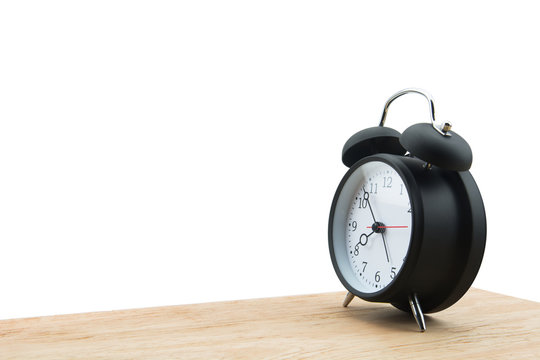 Alarm clock isolated on wooden floor