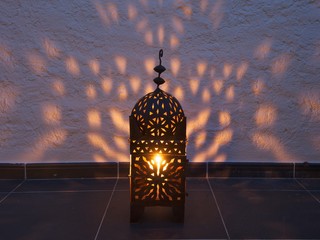 Arabesque - a Moroccan lantern casts shadows on a wall