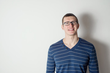 Portrait of a cheerful young man wearing glasses