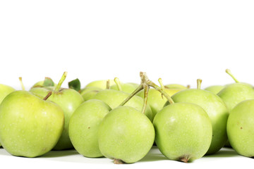 Little green apples isolated on white, with clear space to write on top