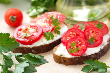 Sandwiches with creamy cheese and fresh tomatoes