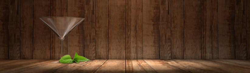 Banner - Leeres Cocktailglas mit Holzhintergrund und Minzblatt