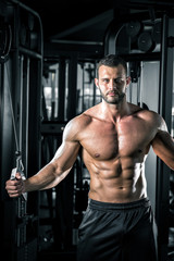 Man doing cable fly in gym