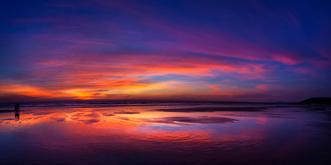 Sunset on fire. Really bright and colorful sunset at the sea with reflection of the skies in the water. 