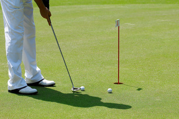 Golf ball behind driver at driving range