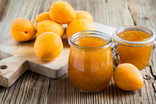 Homemade organic apricot jam in glass jar and ripe apricots