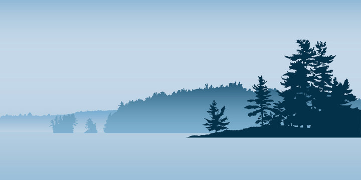 Misty silhouette of the landscape of a northern lake with pine forest and isalnds.