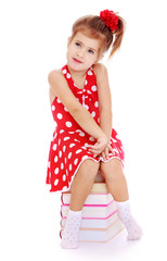 Girl sitting on books