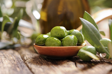 Olive oil with fresh olives
