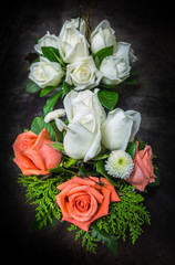 still life decorated orange and white roses on dark tone background