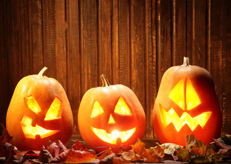 Jack o lanterns  Halloween pumpkin face on wooden background and