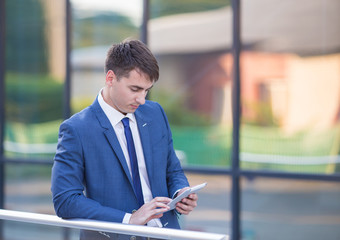 young business man think look up hold tablet pc computer