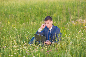 businessman is working in the nature. 