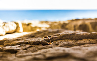 Wedding rings on a coast