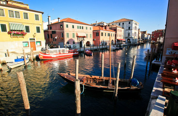 Fototapeta na wymiar Boats on a canal in the Italian town