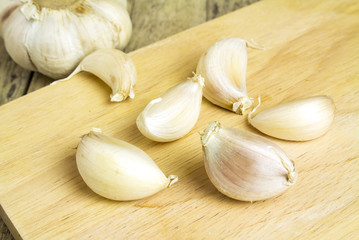group of garlic on cutting board