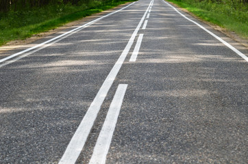 Asphalt road with a white marking