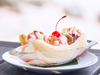 Banana split ice cream with whipped cream and cherry