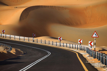 Winding road and sand dunes in Liwa, United Arab Emirates