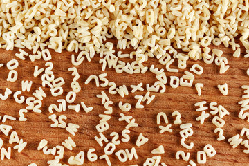 Alphabet pasta on wood background